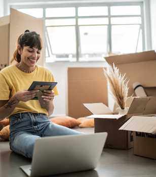 Person unpacking from a move and smiling