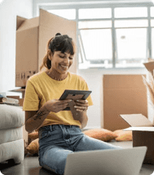 Person unpacking from a move and smiling